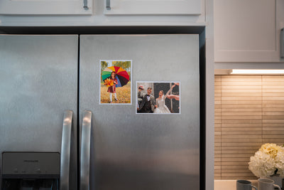5x7 inch Magnetic photo pocket frames with inserted stock photos displayed on stainless steel fridge.
